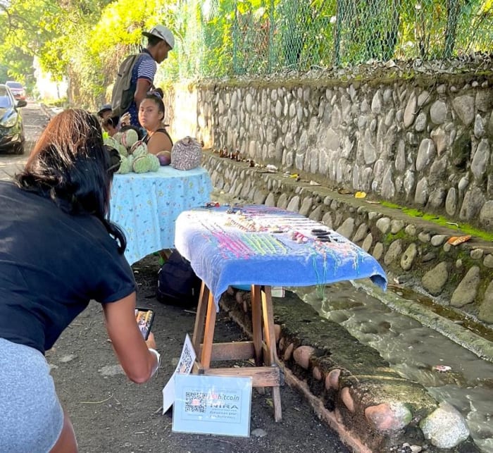 Lola about to buy a bracelet at Bitcoin Beach, El Salvador.